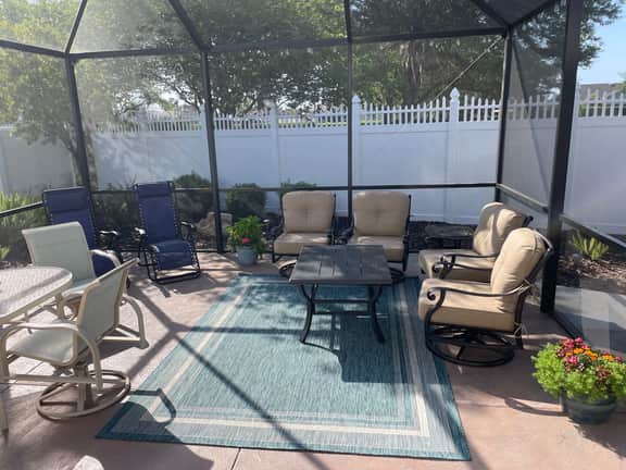 Sunlit open-concept retreat w/granite kitchen island, golf cart & dual lanai.
